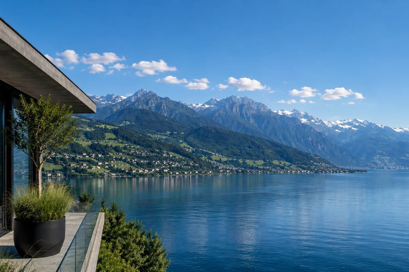 Lac suisse bordé de montagnes enneigées, vu depuis une terrasse